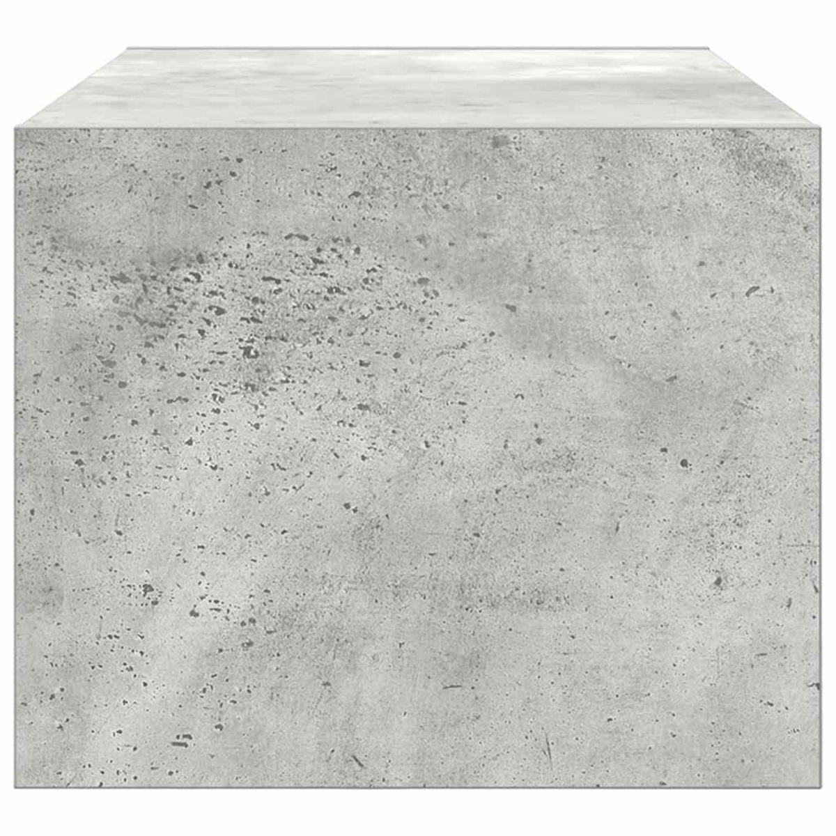 Ein grauer Betonwürfel mit unebener Textur und dunklen Sprenkeln.