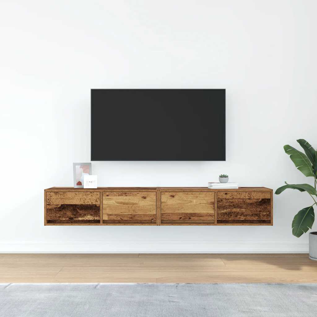 Ein moderner Wohnzimmeraufbau mit einem Holzfernsehmöbel und einem großen schwarzen Fernseher.