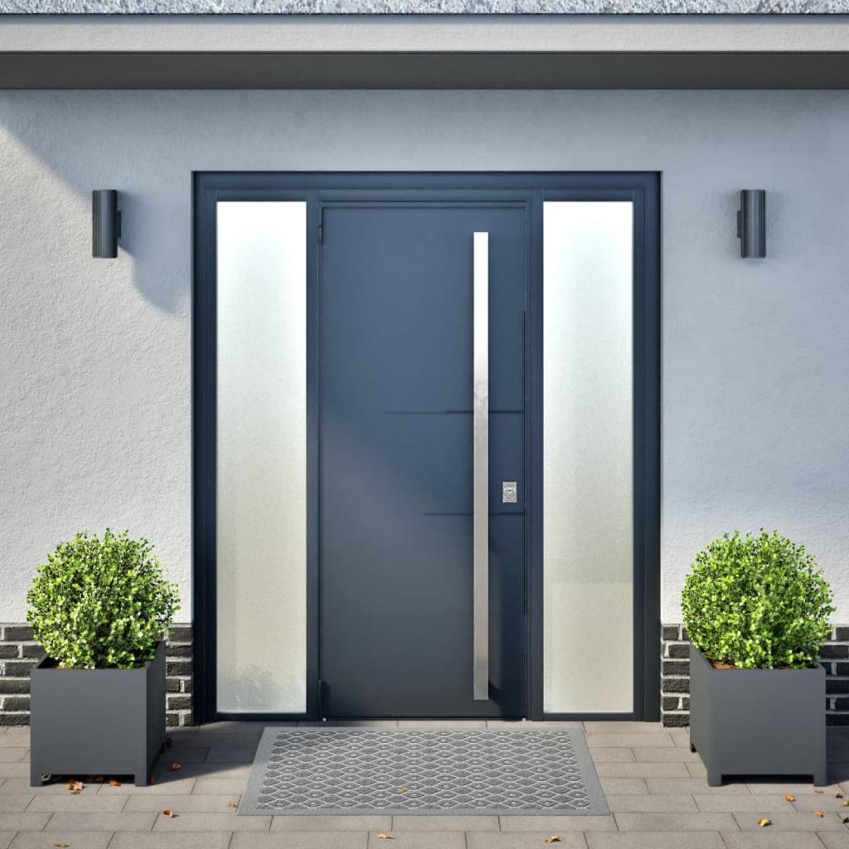Una moderna porta d'ingresso grigio scuro con accenti in vetro, fiancheggiata da due cespugli.