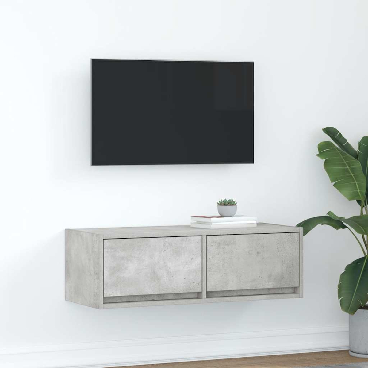 Ein modernes Wohnzimmer mit einem Wandfernseher, einem schwebenden Schrank und einer Pflanze.