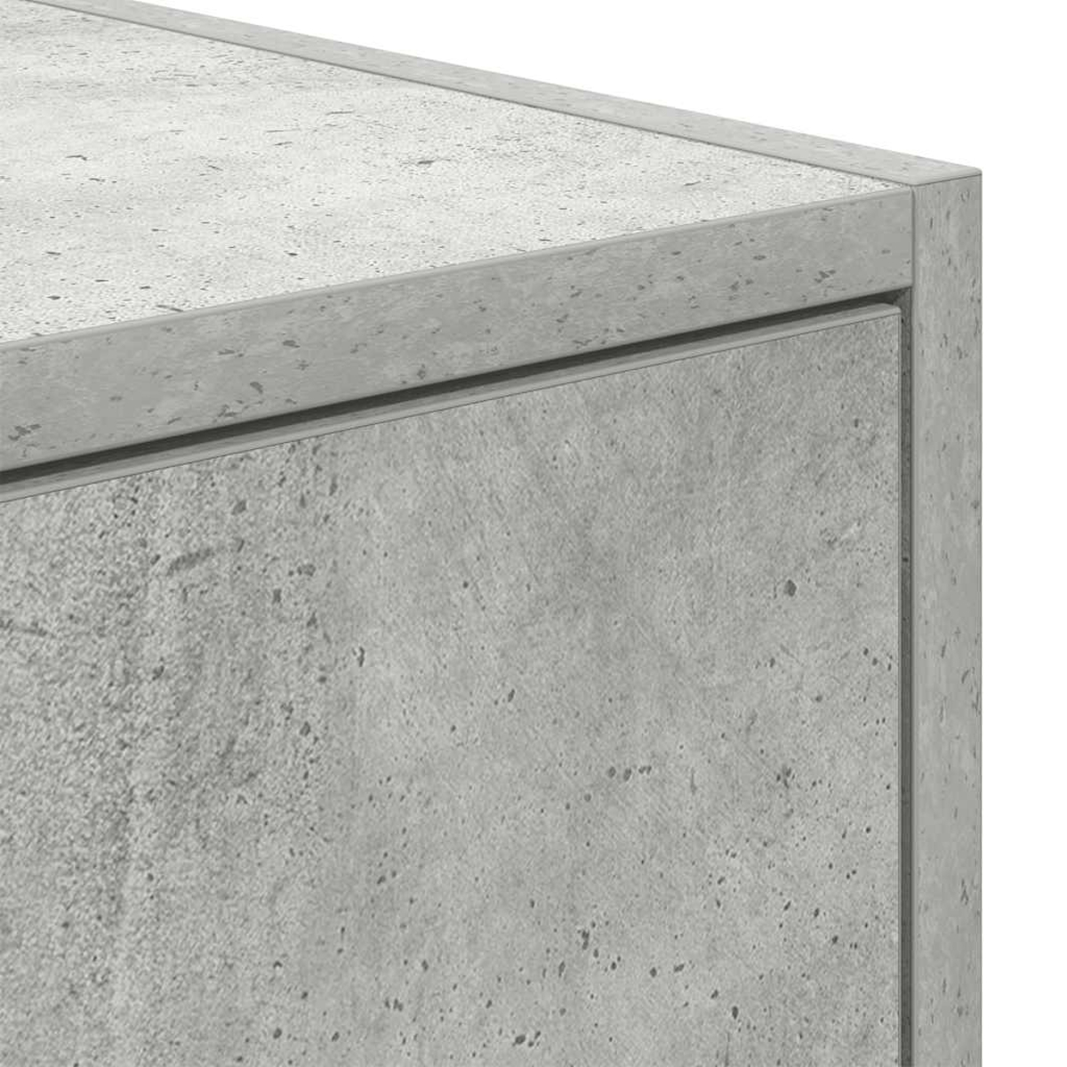 Nahaufnahme einer grauen Betonoberfläche mit sichtbarer Textur und kleinen Sprenkeln.
