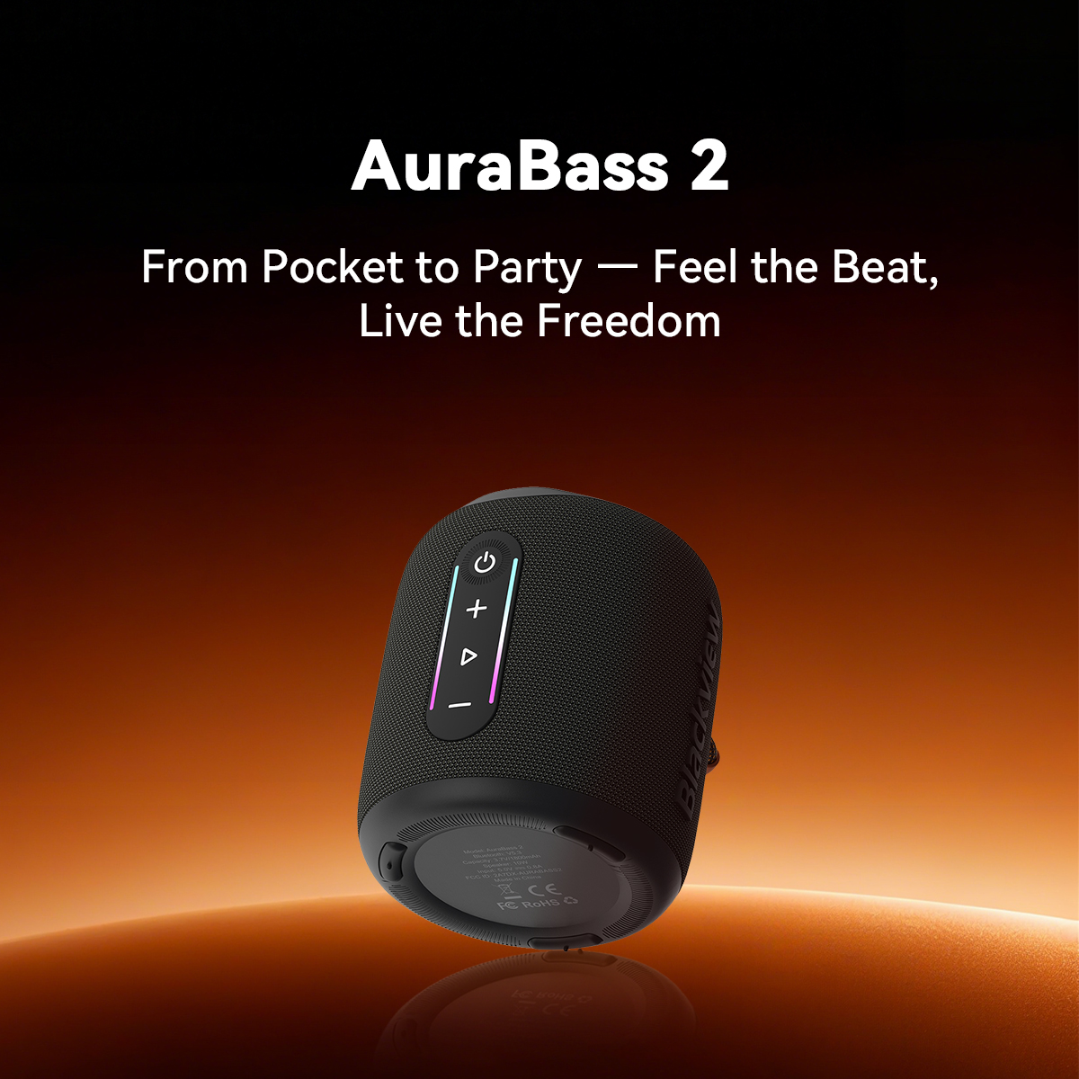 Black portable speaker with control buttons and colorful light accents on orange background.