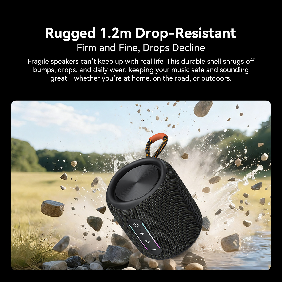 Black speaker with strap falls into water, rocks flying.