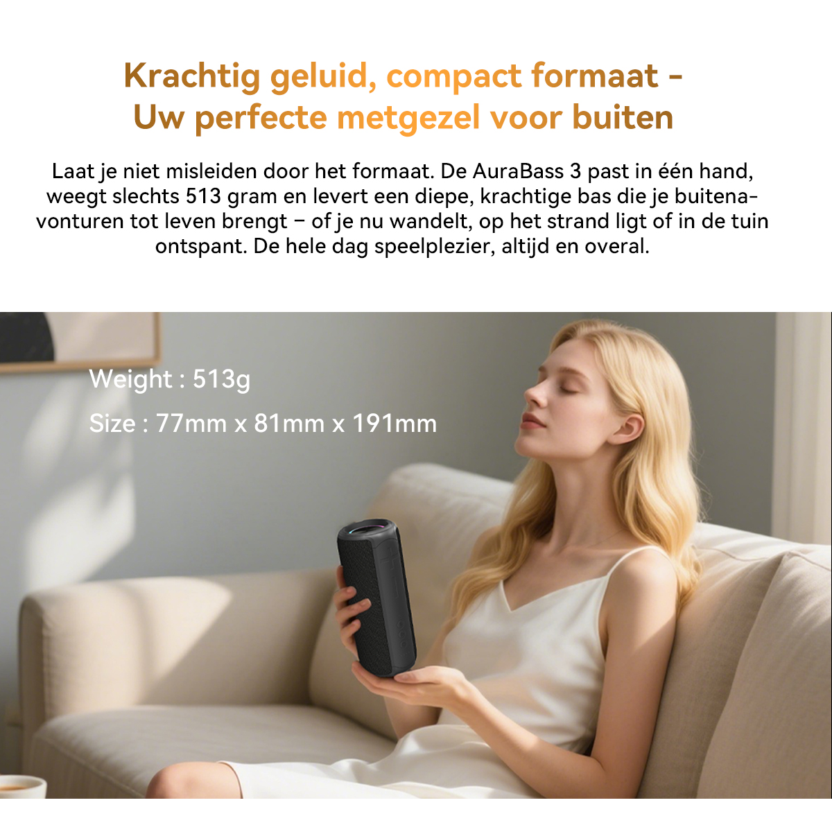 A woman holds a black speaker while sitting on a couch.