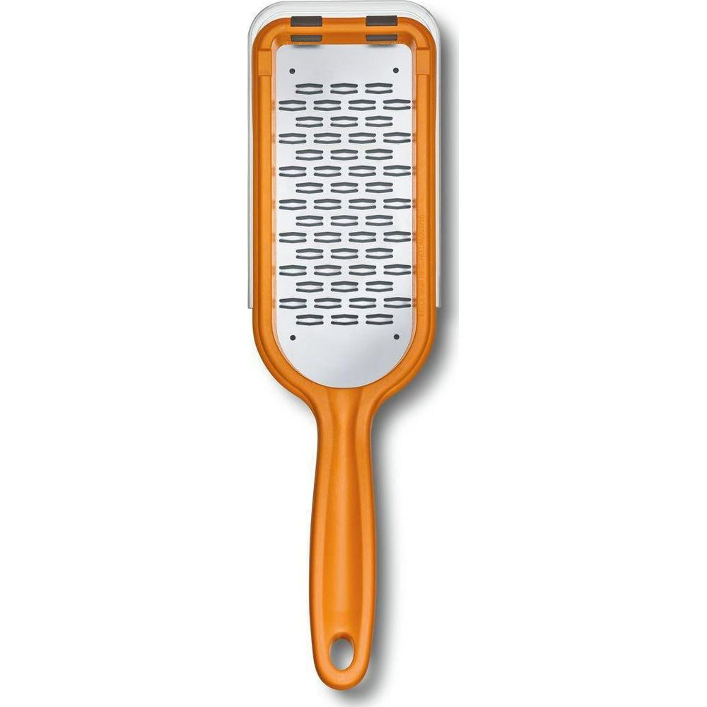 Ein orangener Fußhärter mit weißer Reibe-Oberfläche und schwarzem Griff.
