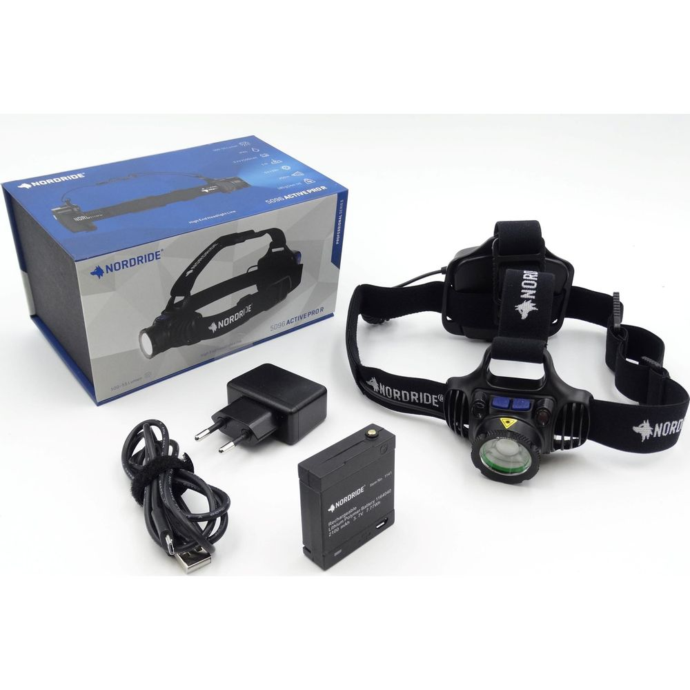 Lampe frontale Nordride avec accessoires : boîte, lampe, batterie, chargeur et câble.