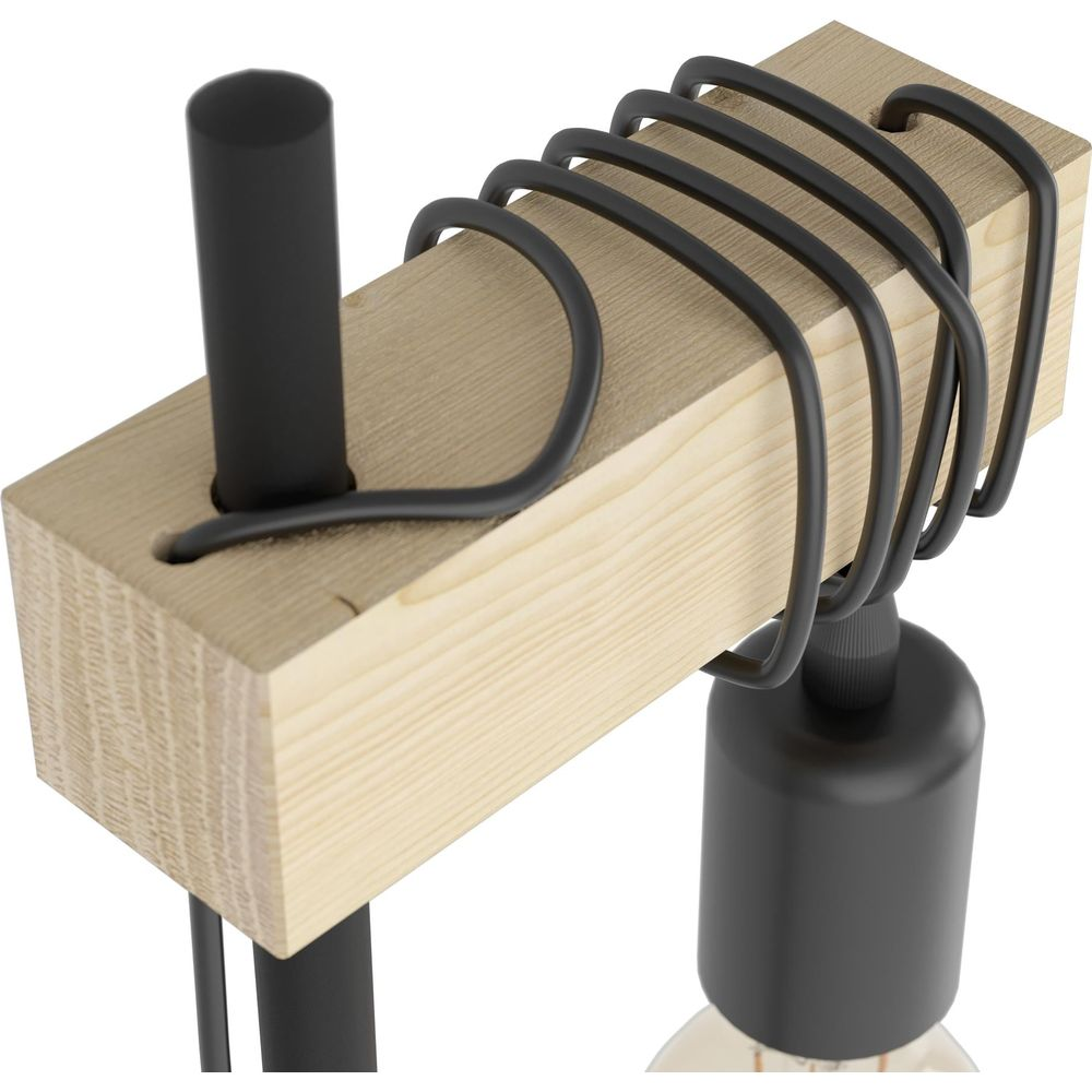 Ein schwarzer Draht wickelt sich um einen Holzbalken mit einer schwarzen Lampe.
