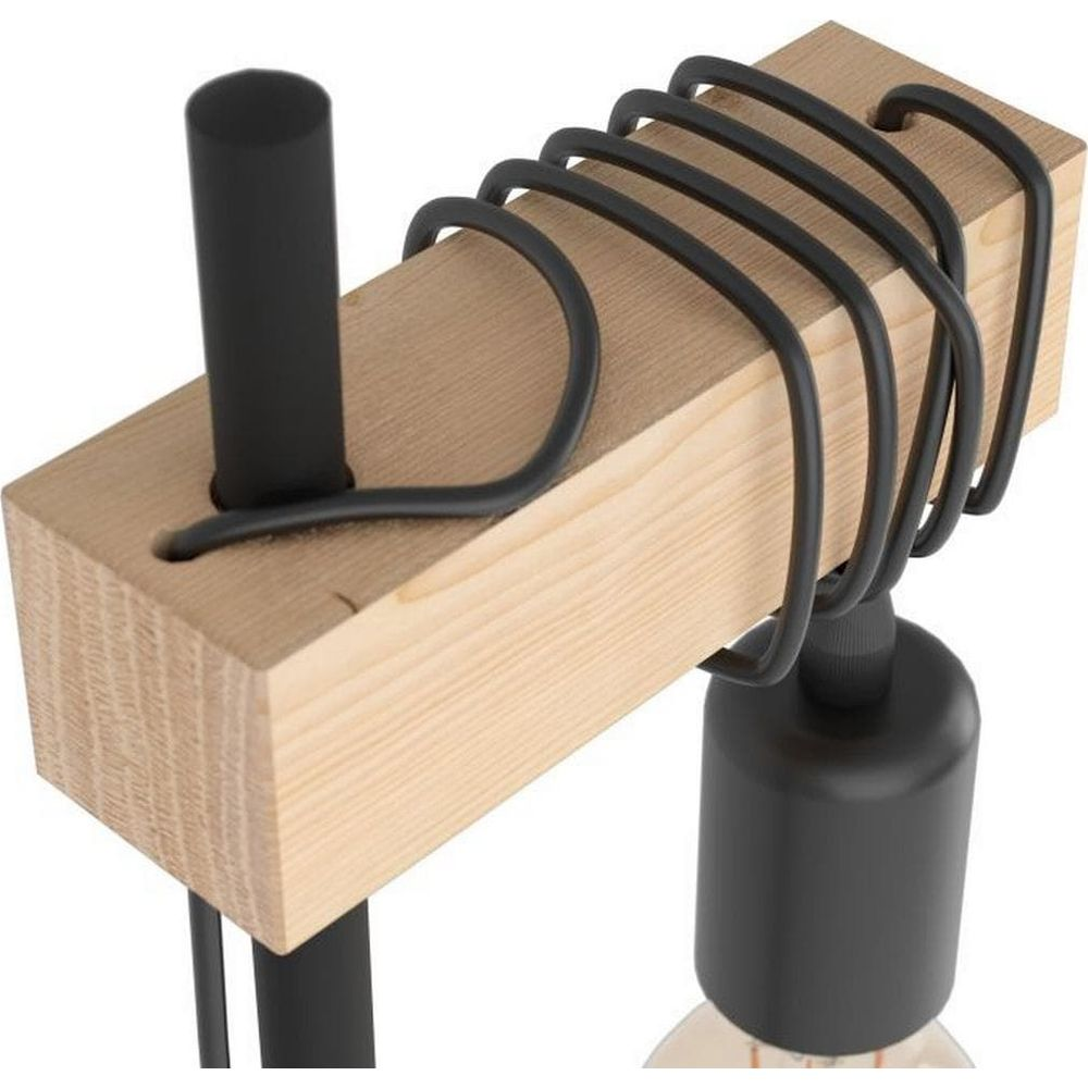 Holzblock mit schwarzem Metallgestell und Glühbirne, minimalistisches Design.