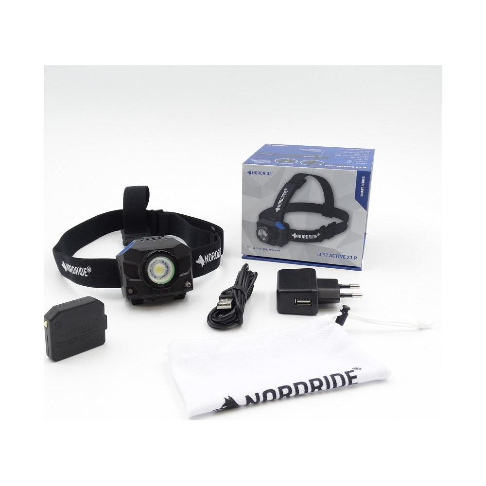 Kit de phare Norddrider avec boîte, câble USB, chargeur, batterie et chiffon.