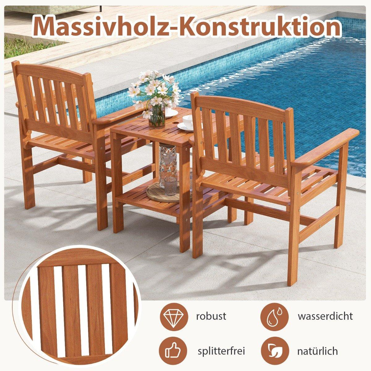 Two wooden chairs and a table by the pool with flowers and glasses.
