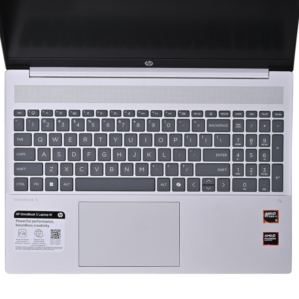 Otwarty laptop z klawiaturą, touchpadem i logo AMD. Ekran znajduje się na górze.