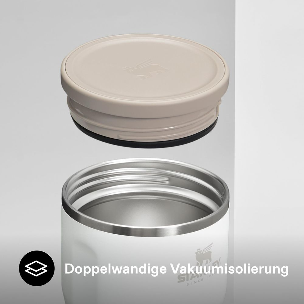 Une tasse blanche avec un couvercle beige à côté. Le texte est en allemand.