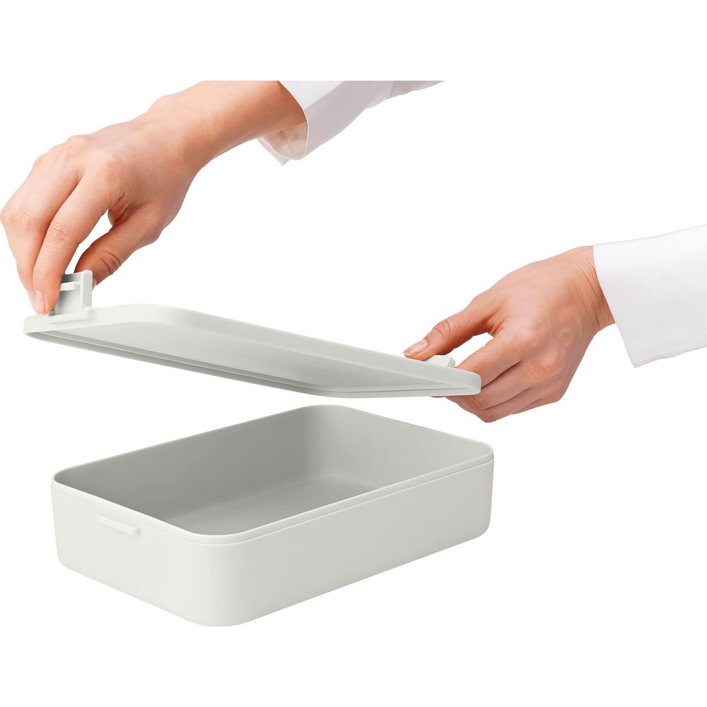 Contenitore grigio con coperchio tenuto da due mani.