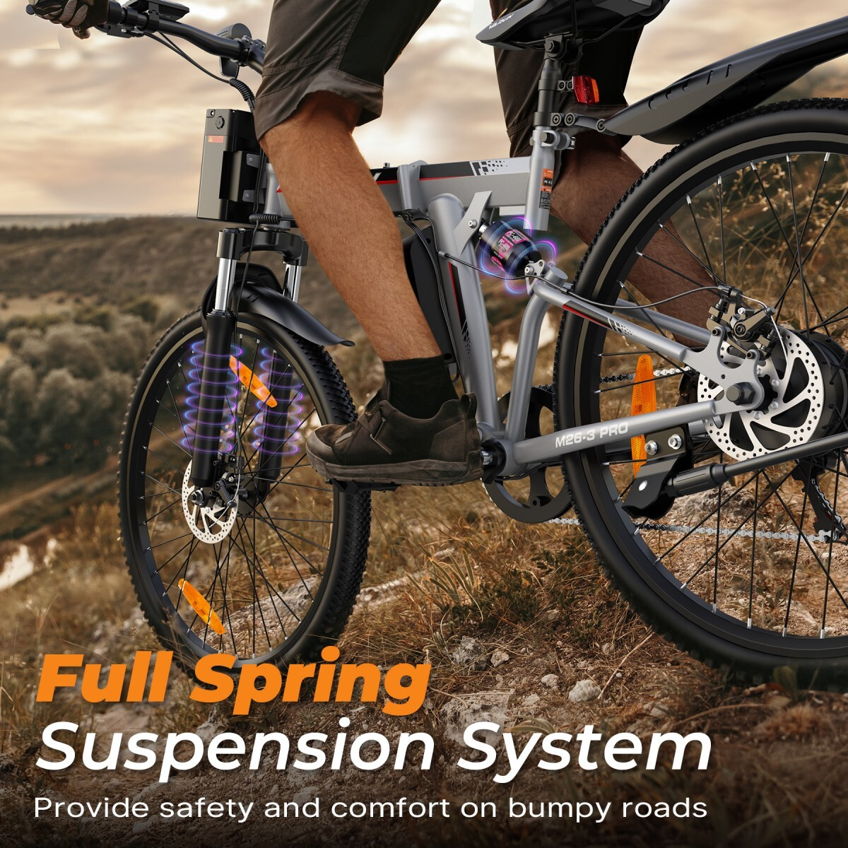 Mężczyzna jedzie rowerem elektrycznym z pełnym zawieszeniem po nierównym terenie.