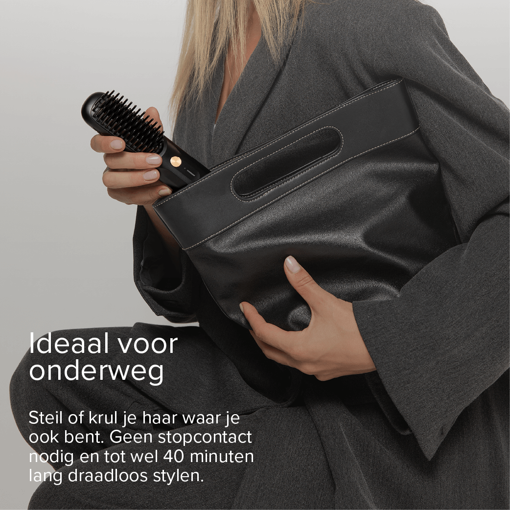 Woman holding a black hair straightener and clutch. Ideal for travel.