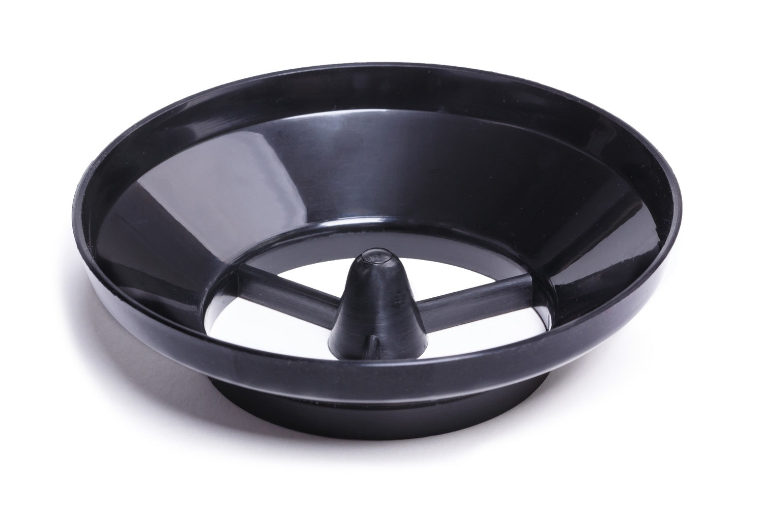 A black plastic cone-shaped object with three supports inside a shallow dish.