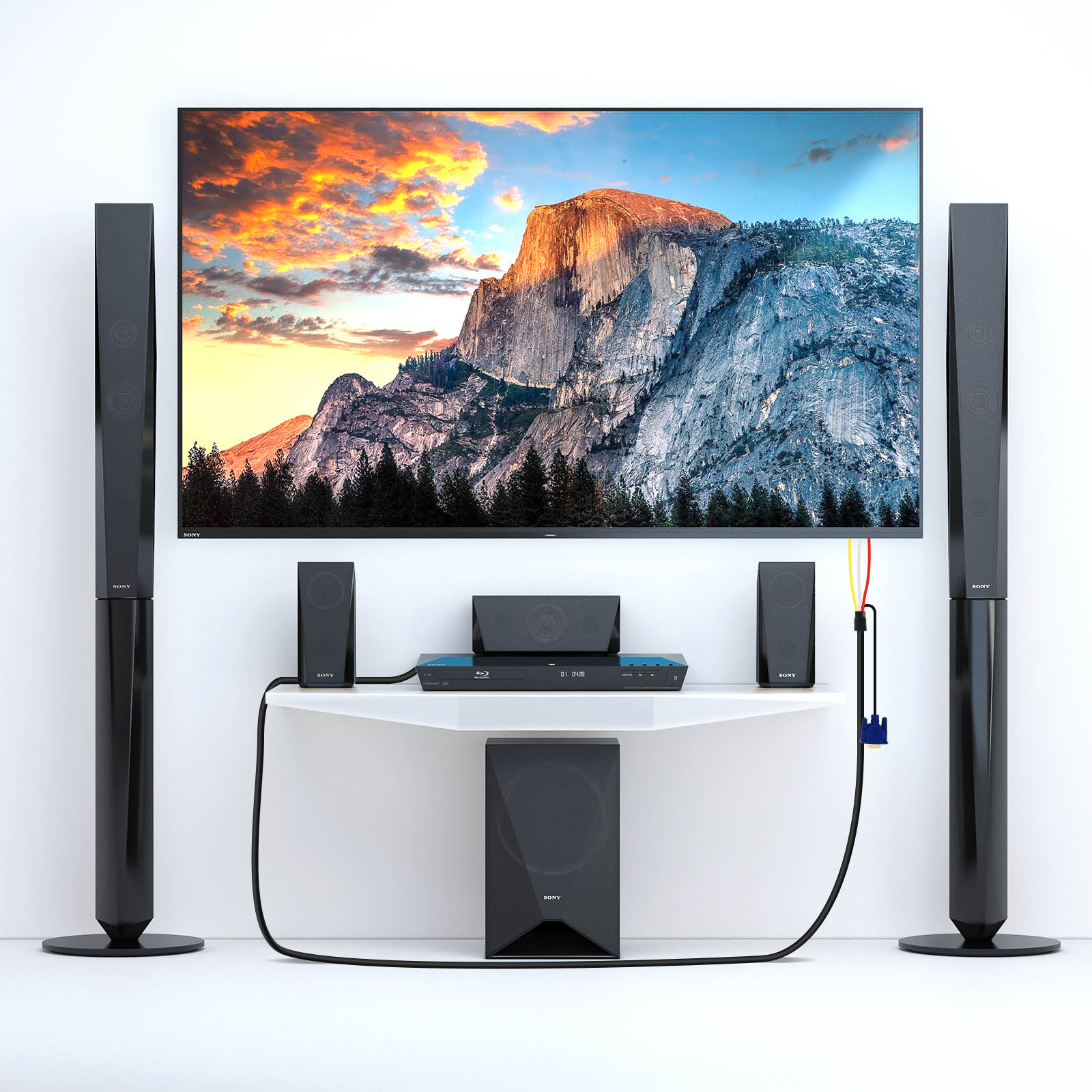 Un grande televisore mostra un paesaggio montano, con altoparlanti e un lettore Blu-ray.