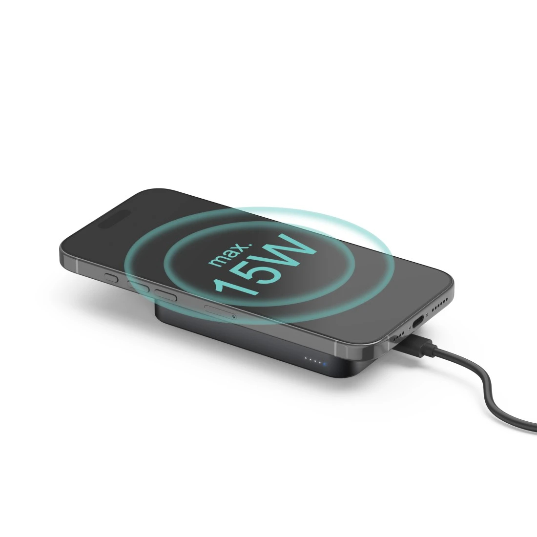 Czarny smartfon ładuje się na czarnej ładowarce bezprzewodowej. Maks. 15W.