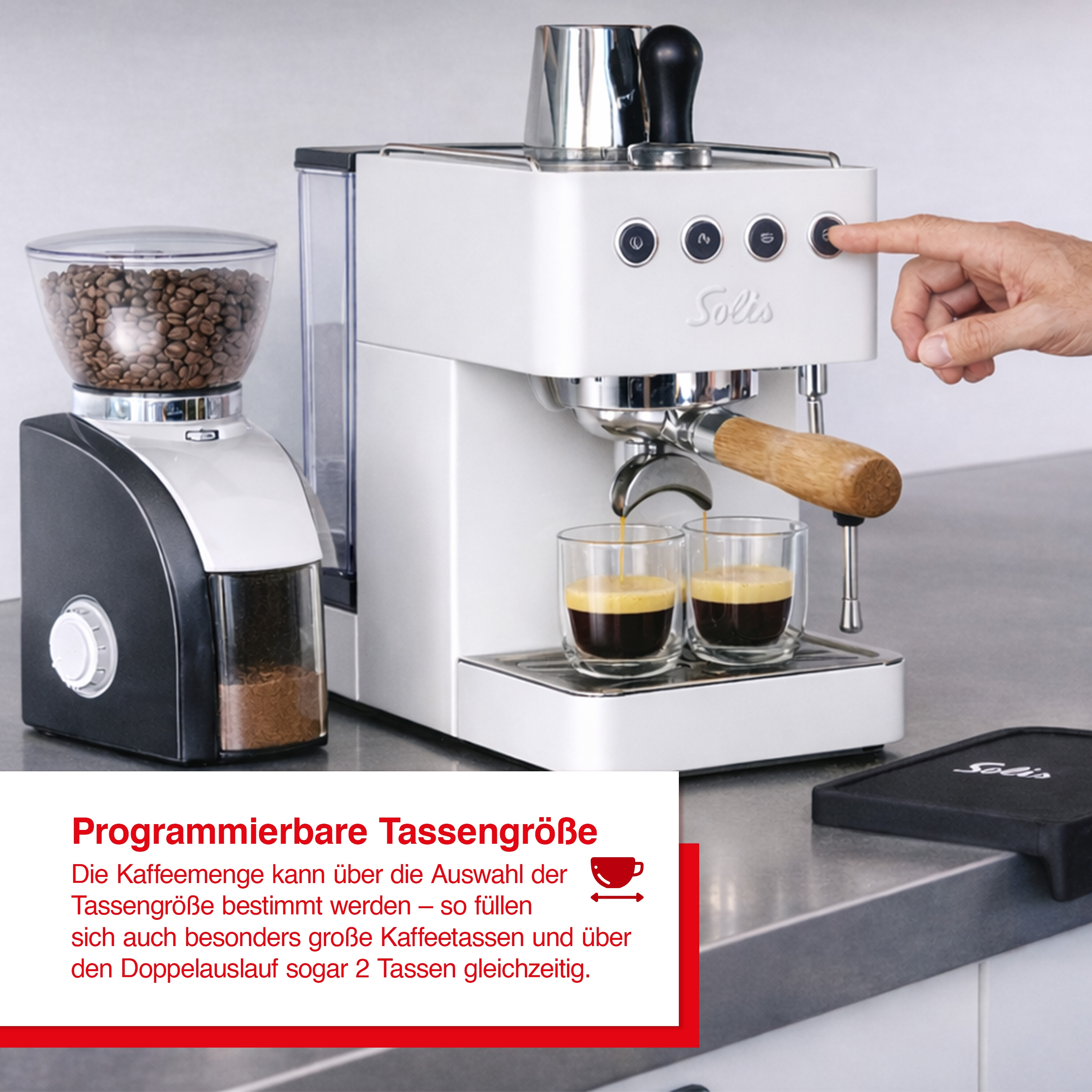 Eine weiße Kaffeemaschine mit Kaffeemühle brüht Kaffee in zwei Gläser.
