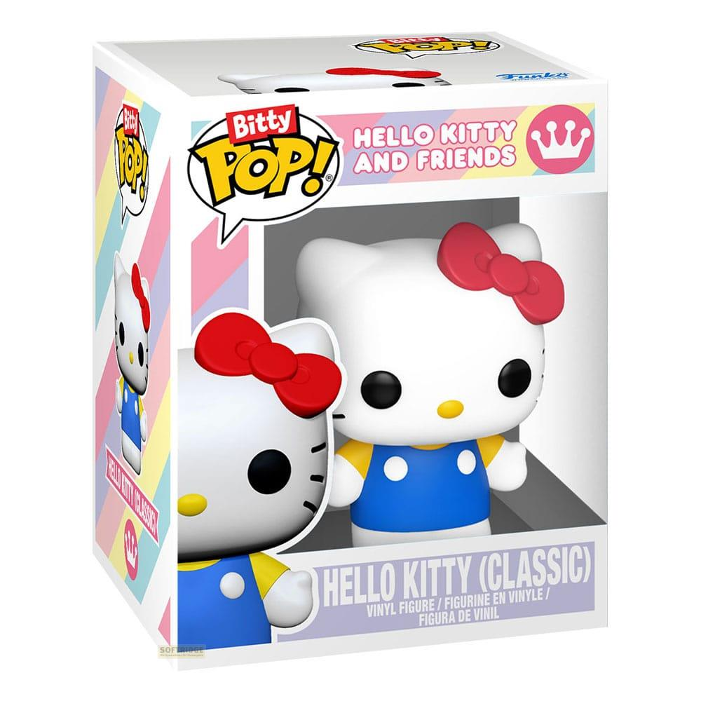 Dos figuras de vinilo de Hello Kitty en caja, lazos rojos, petos azules.