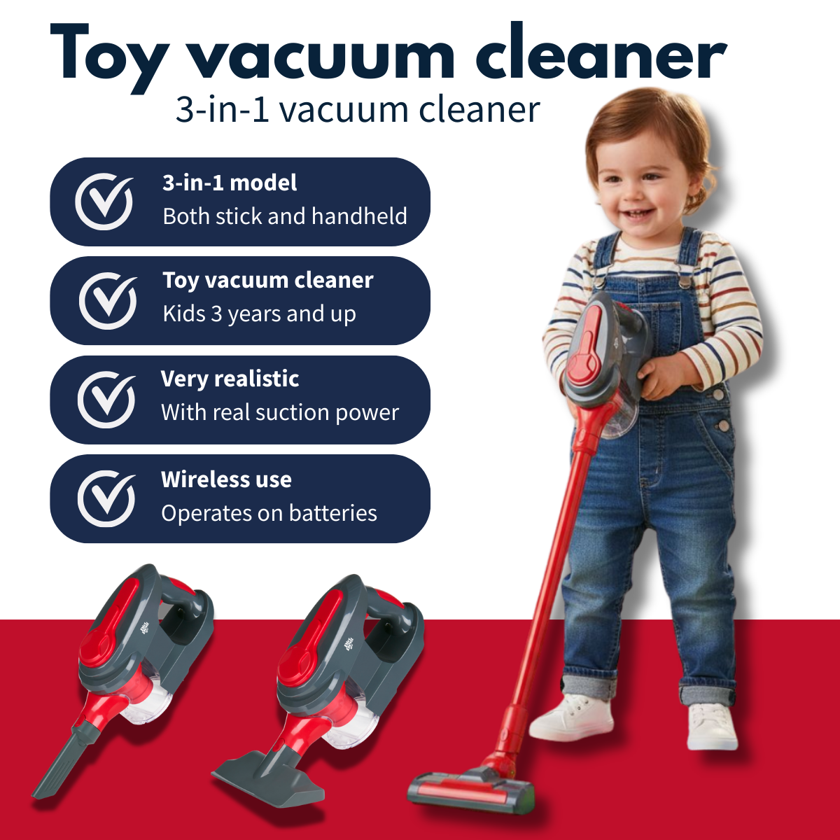 A smiling toddler stands next to a toy vacuum cleaner with red accents.
