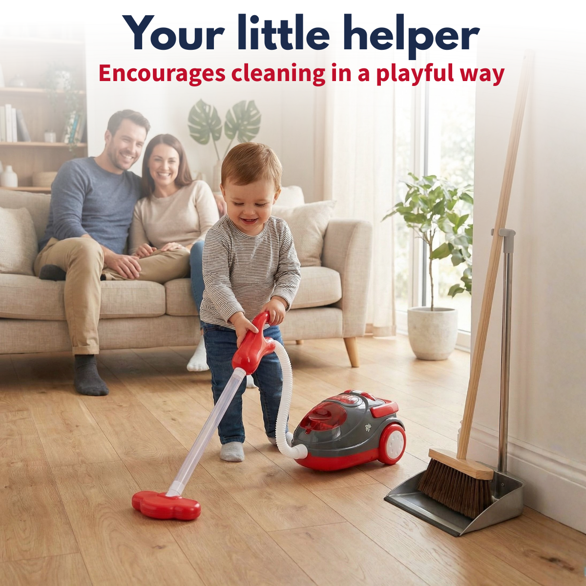 A child plays with a toy vacuum cleaner while parents watch.