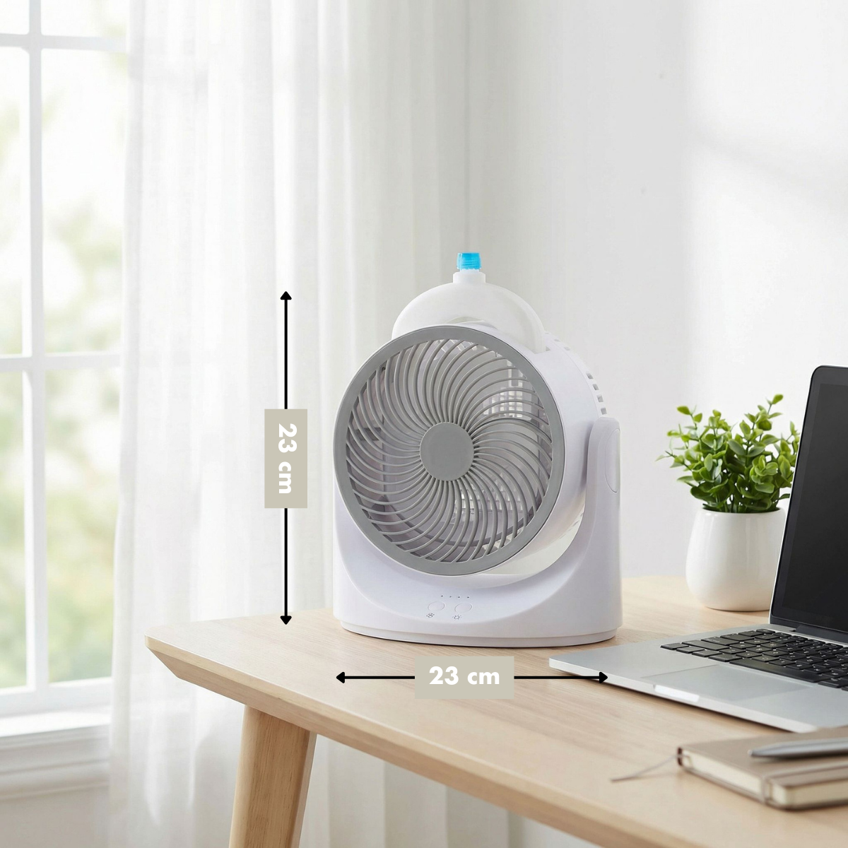 A white desk fan with grey blades sits on a wooden table.