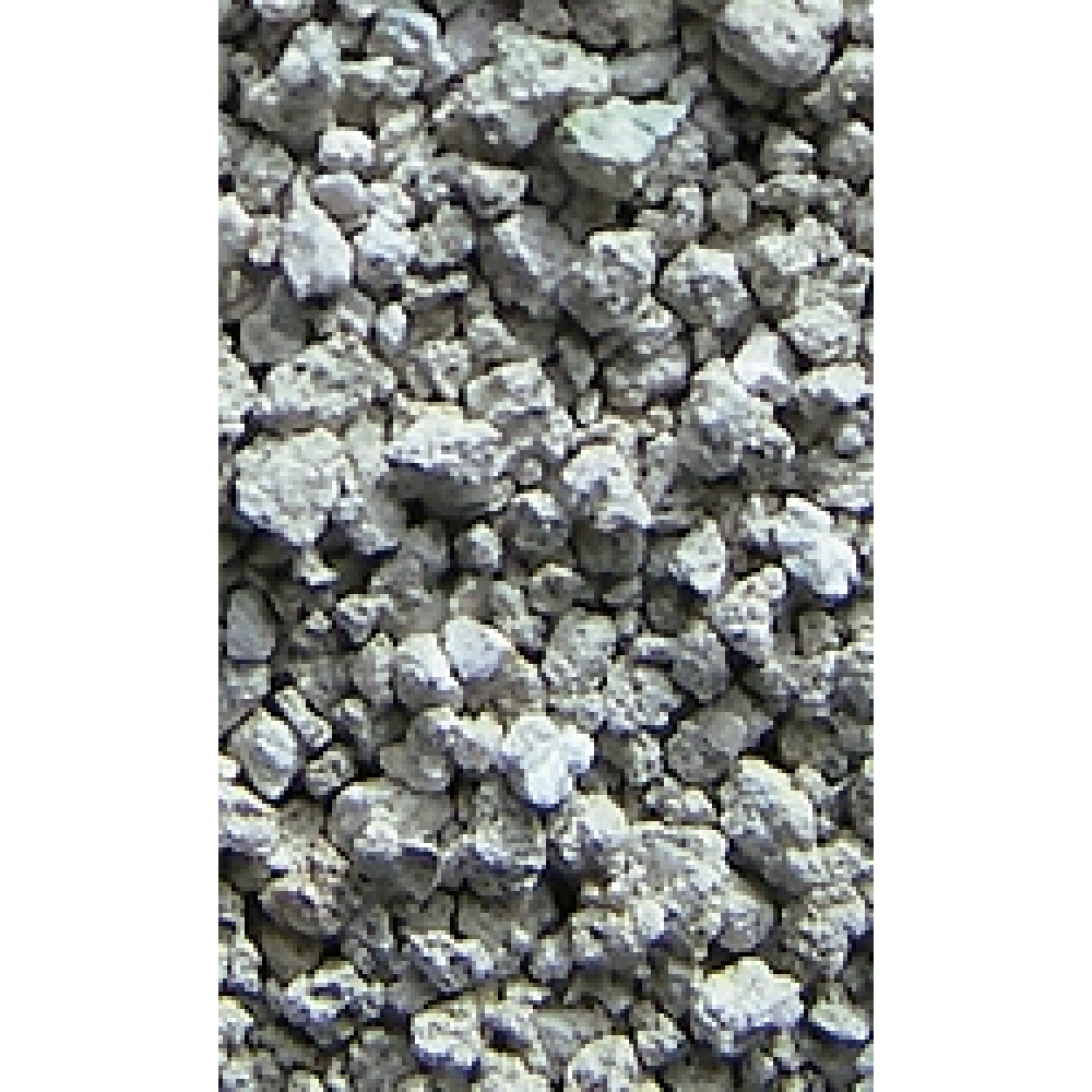 Primo piano di materiale grigio e granulare con forme e texture irregolari.