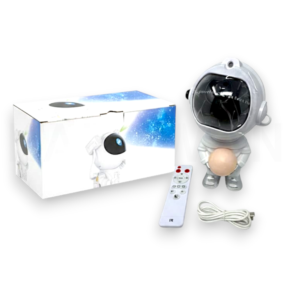 Proyector de astronauta, caja, control remoto y cable de carga sobre fondo blanco.