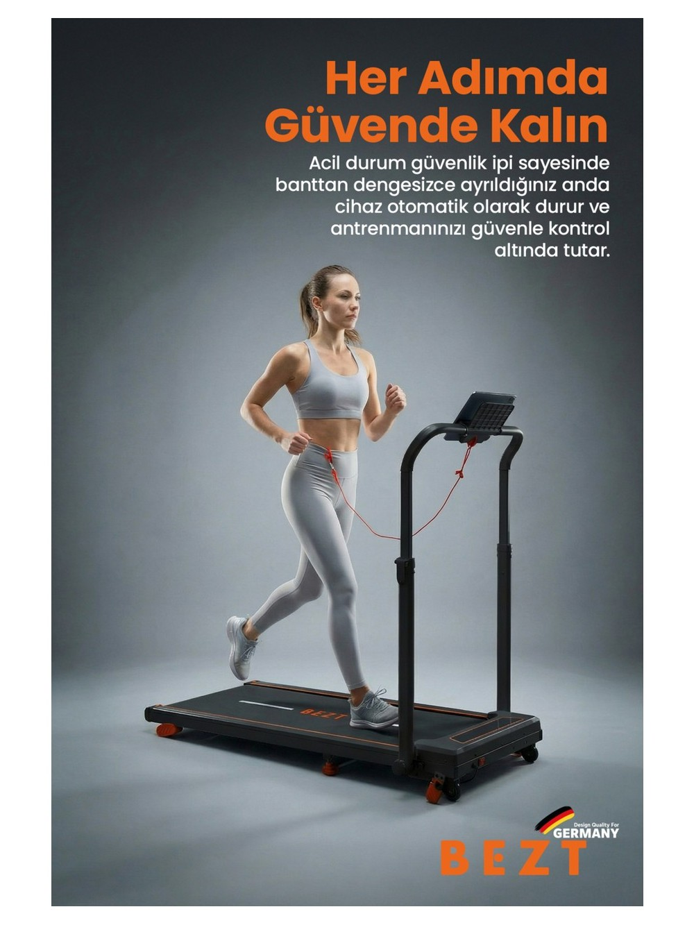 Gri spor kıyafetli kadın koşu bandında koşuyor. Kırmızı güvenlik ipi bağlıdır.