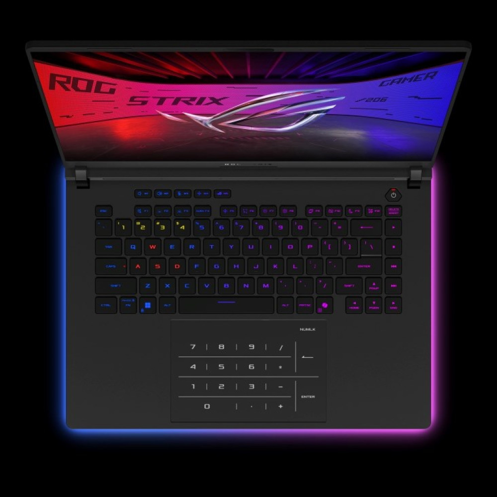 Otwarty laptop z podświetlaną klawiaturą i logo ROG Strix.