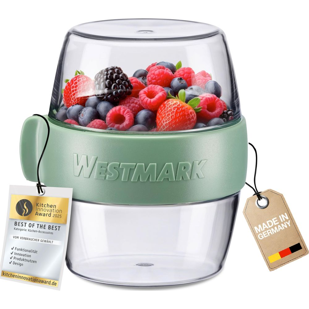 Grüner Westmark-Zerkleinerer mit verschiedenen Beeren gefüllt. Ausgezeichnet.