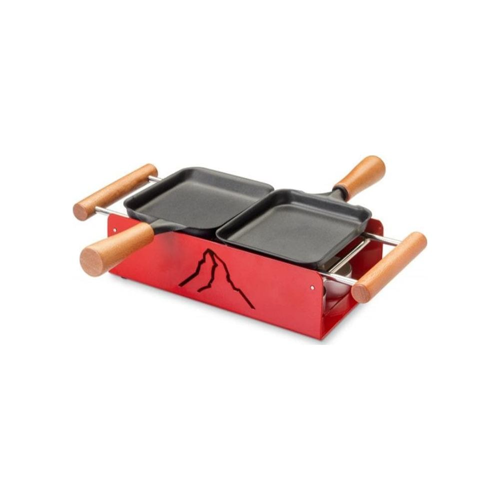 Una griglia per raclette rossa con due padelle nere e manici in legno.