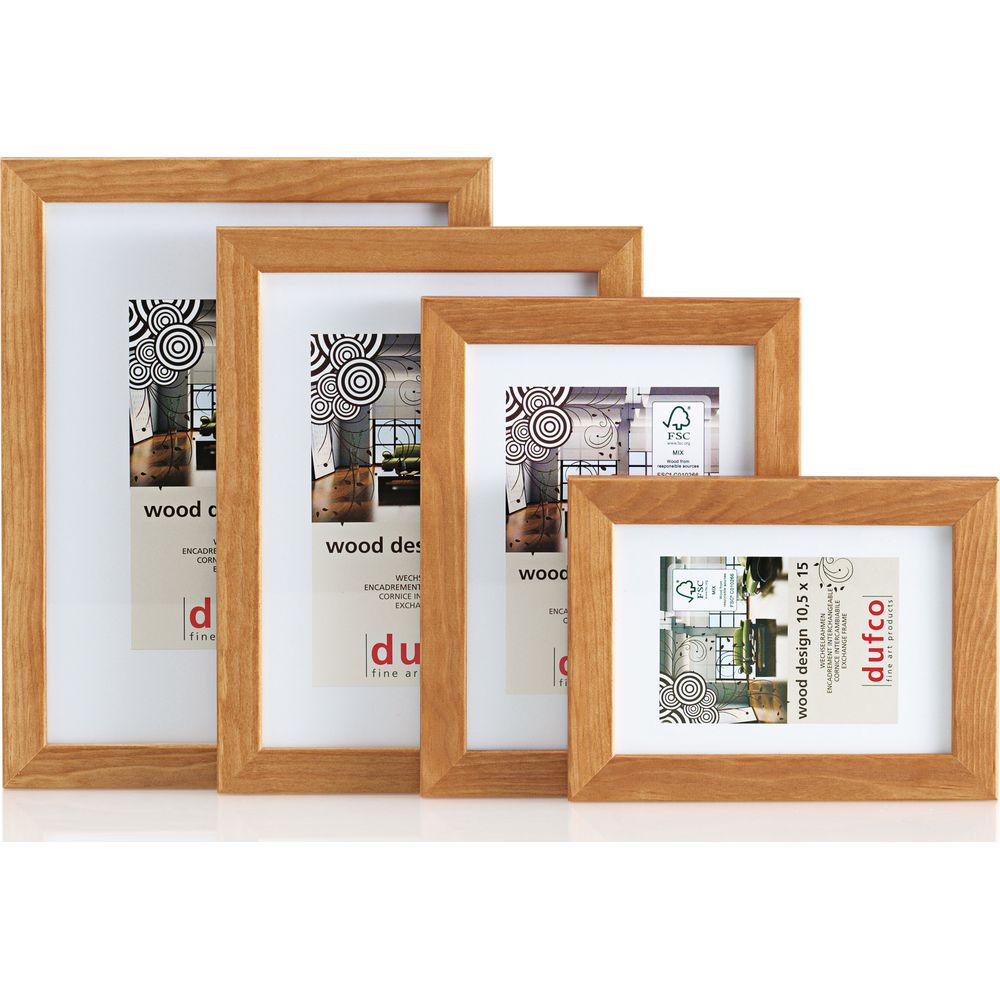 Quatre cadres photo en bois de différentes tailles avec passe-partout blancs.