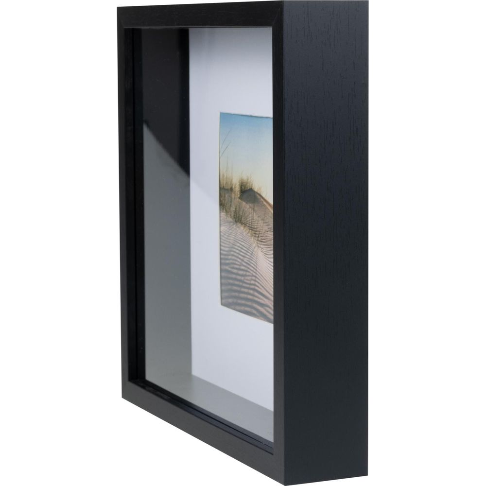 Une boîte d'ombre noire avec une photo de dunes de sable et d'herbe.
