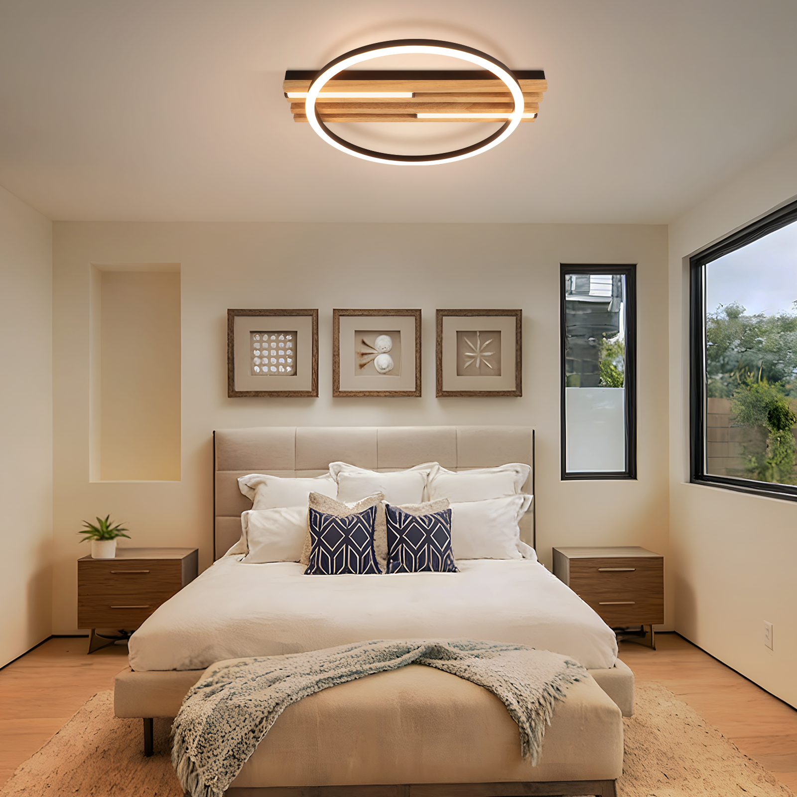 Una camera da letto con letto, comodini, tre opere d'arte incorniciate e una moderna plafoniera.