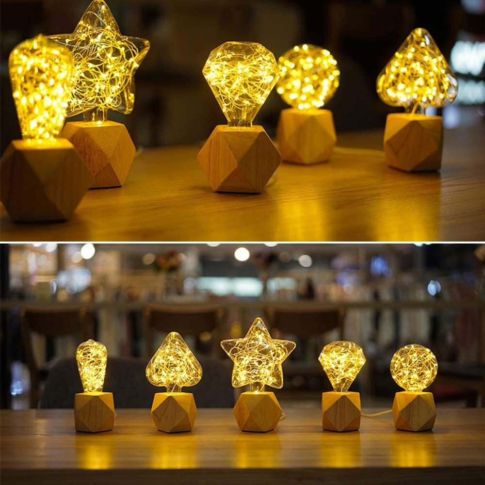 Holzsockelleuchten in Stern-, Diamant-, Kugel- und Baumformen mit warmweißen Lichterketten.