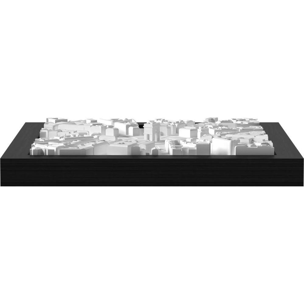 Un paysage urbain blanc sur un socle en bois noir, vu de dessus.
