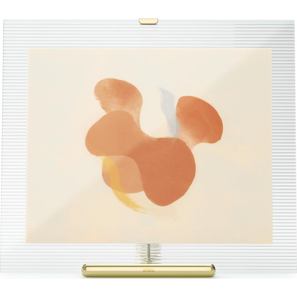 Formes abstraites orange sur fond crème dans un cadre argenté.