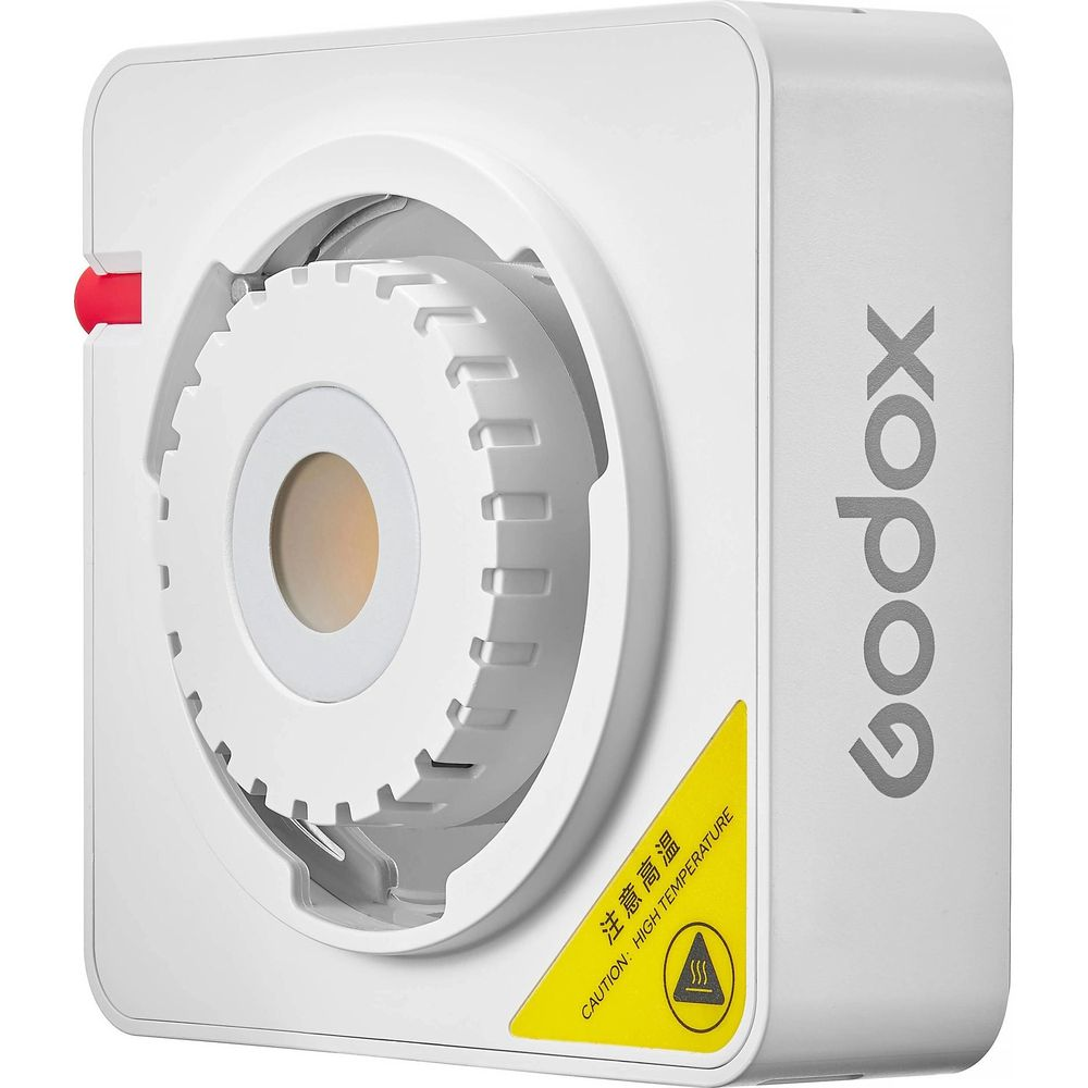 Un appareil blanc Godox avec une molette moletée et un bouton rouge. Panneau d'avertissement.