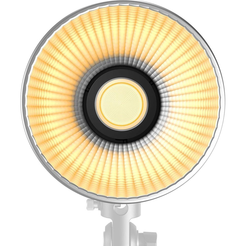 Un réflecteur de lumière annulaire éclairé avec des anneaux concentriques au centre.