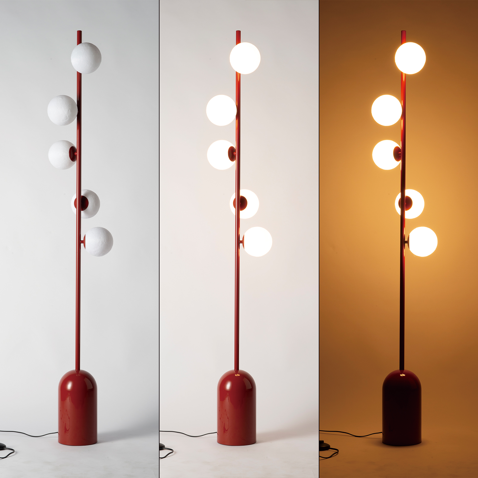 Lámpara de pie roja con seis luces esféricas blancas sobre fondo blanco/amarillo.