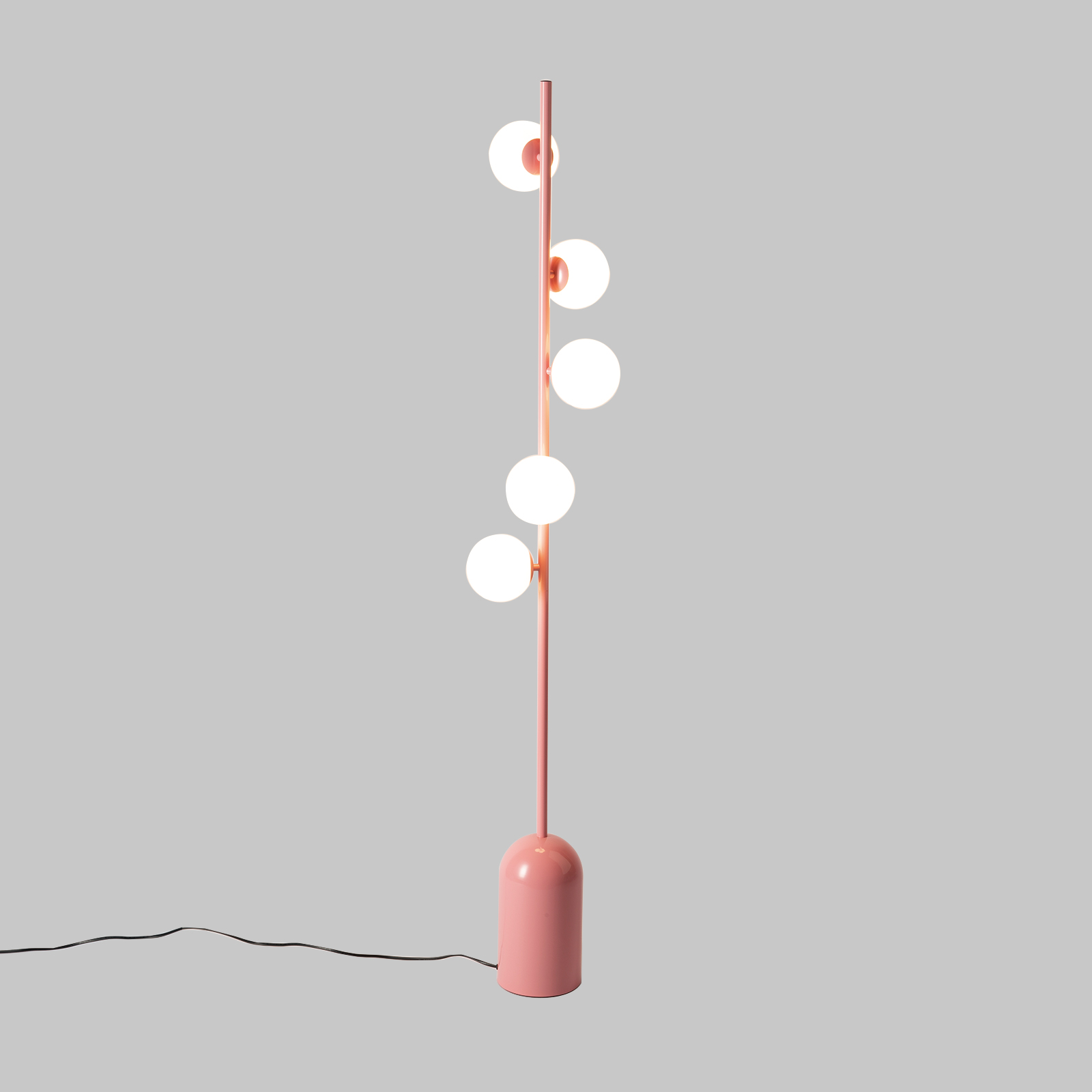 Una lámpara de pie rosa con cinco bombillas esféricas sobre fondo gris.