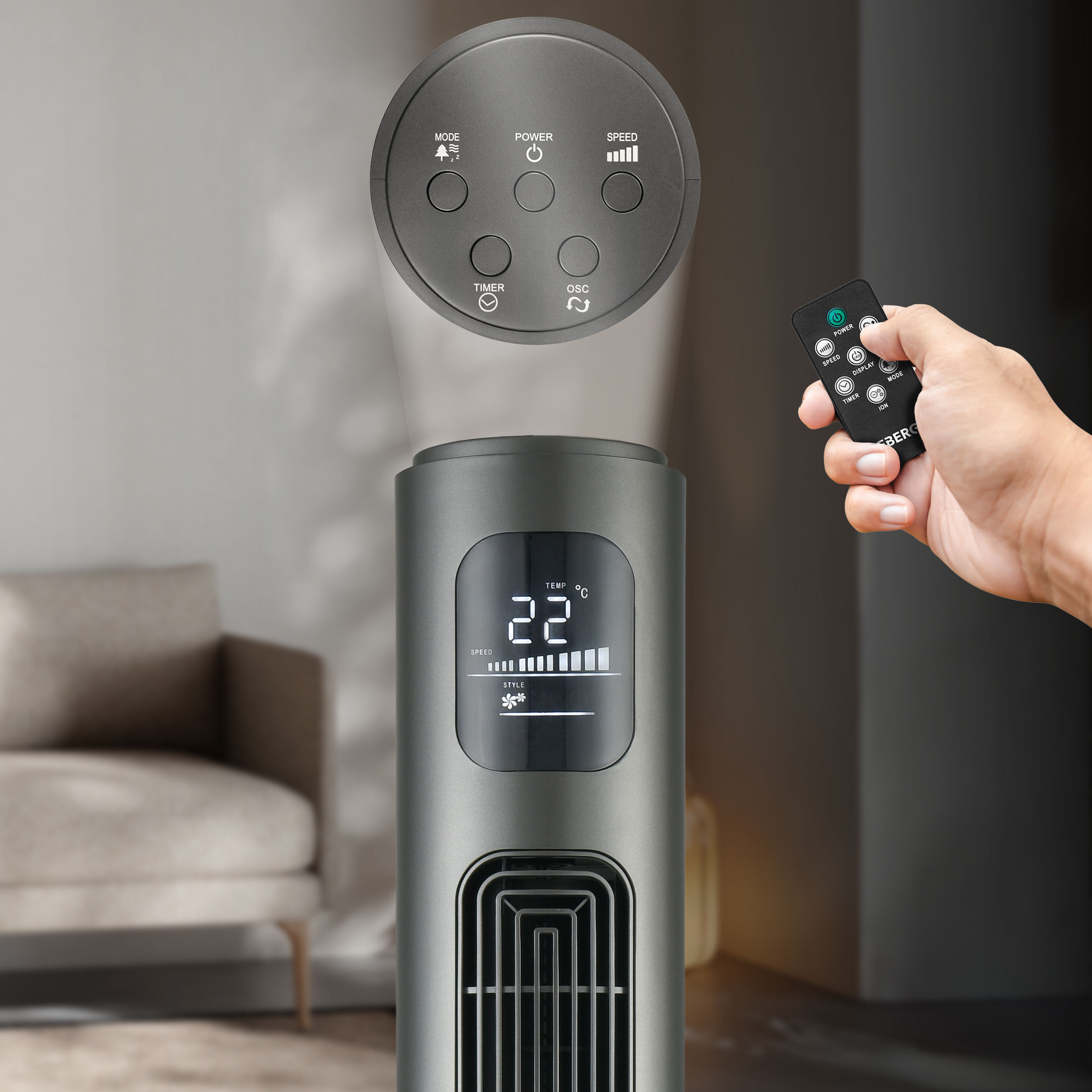 Szara wentylatorka wieżowa z pilotem, pokazuje 22°C i poziom prędkości.
