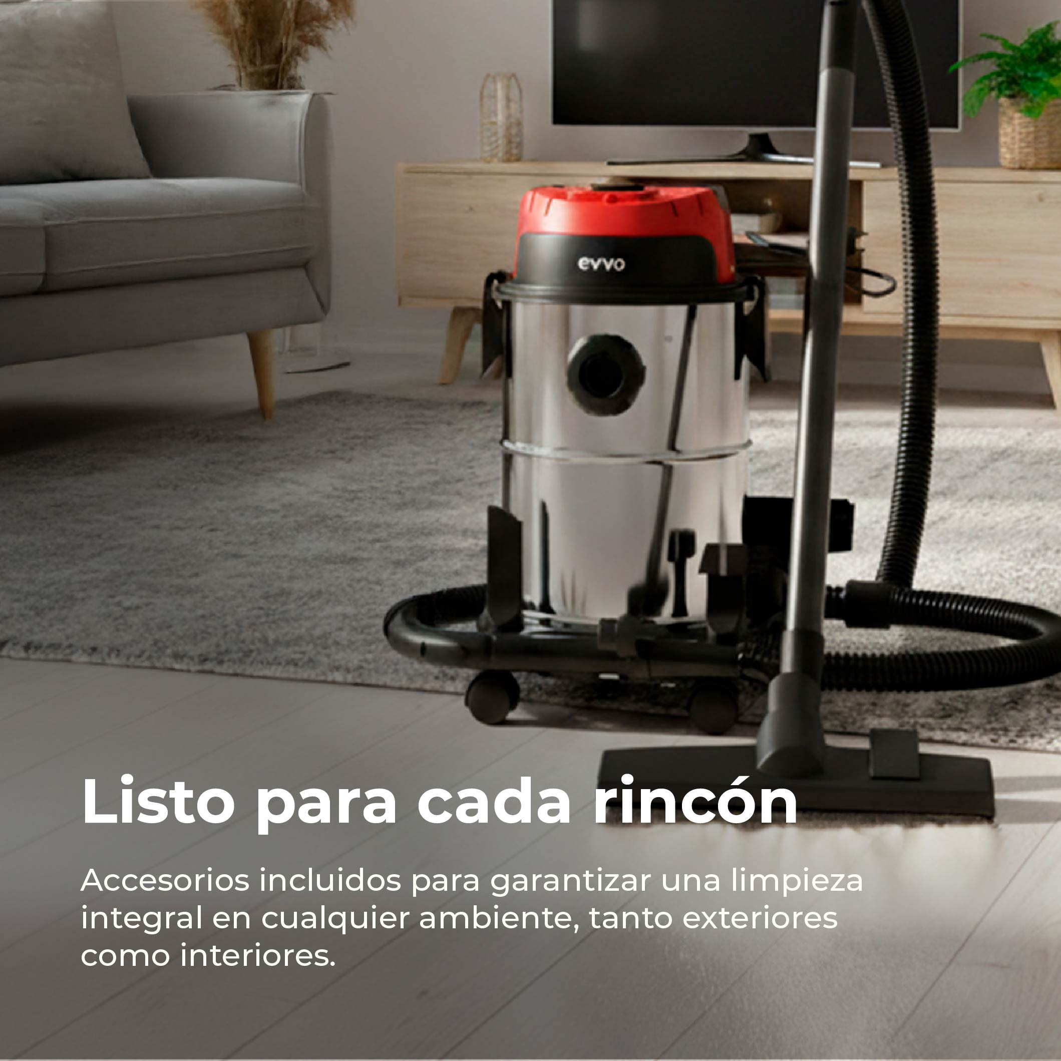 Un aspirapolvere bagnato/asciutto argentato con coperchio rosso è su un tappeto.