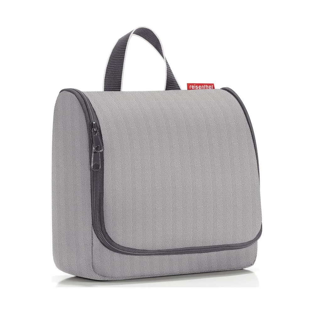 Graue Kulturtasche mit Reißverschluss und Henkel, mit Fischgrätmuster.