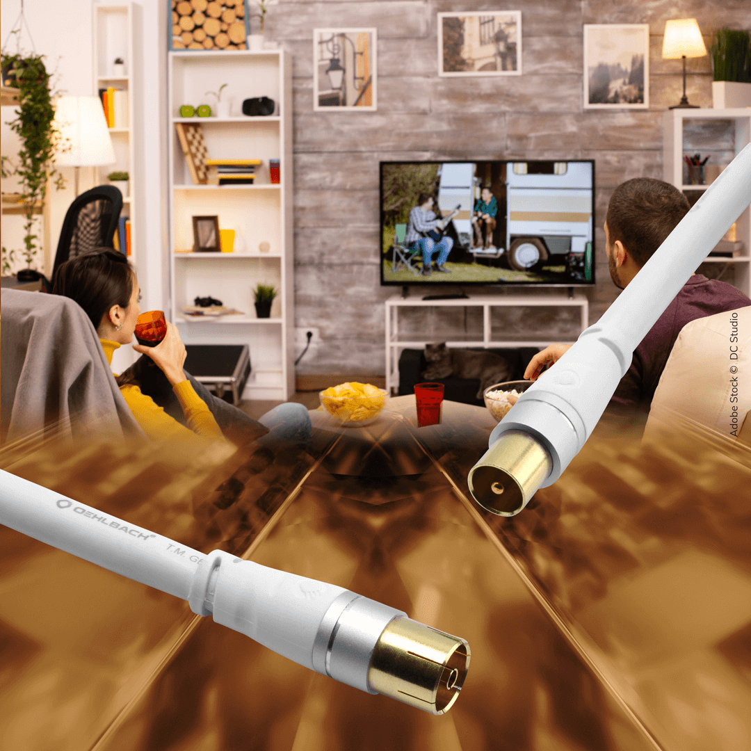 A couple watches TV, with cables in the foreground.