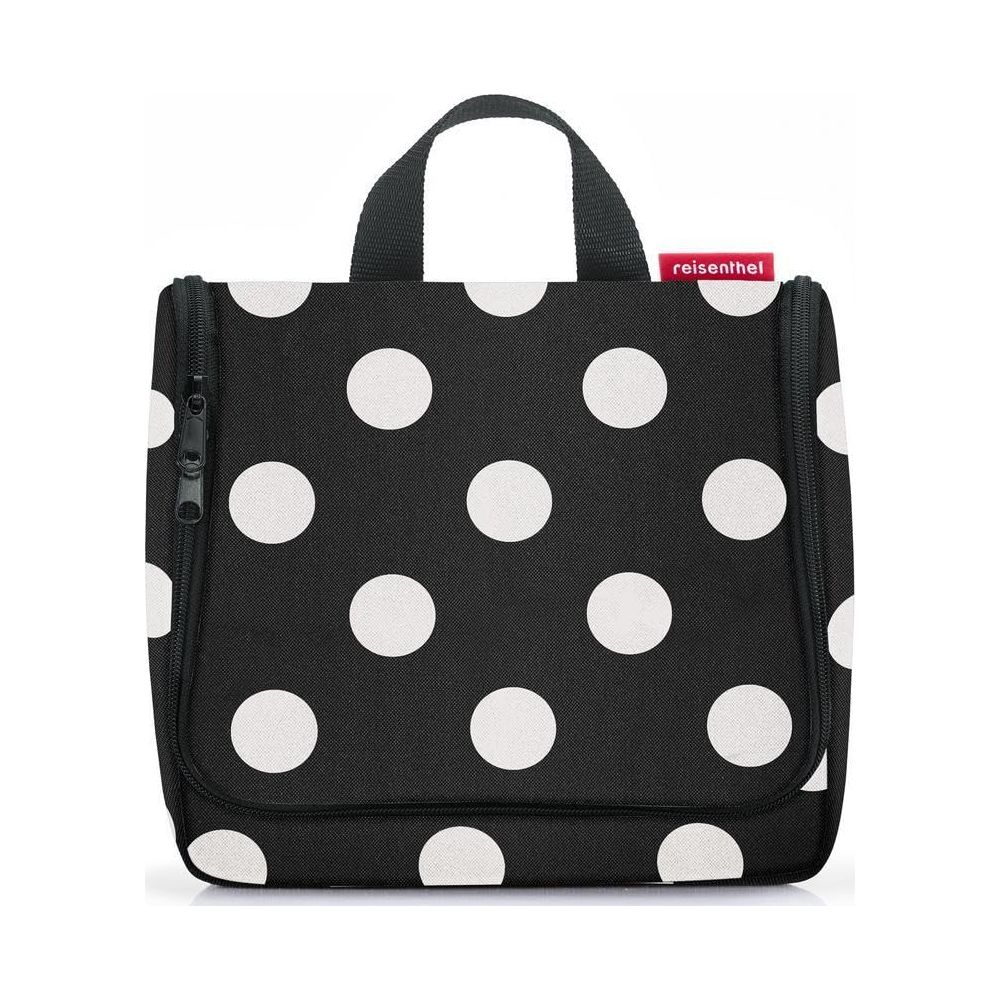 Schwarze Kulturtasche mit weißen Punkten und rotem Markenlogo.
