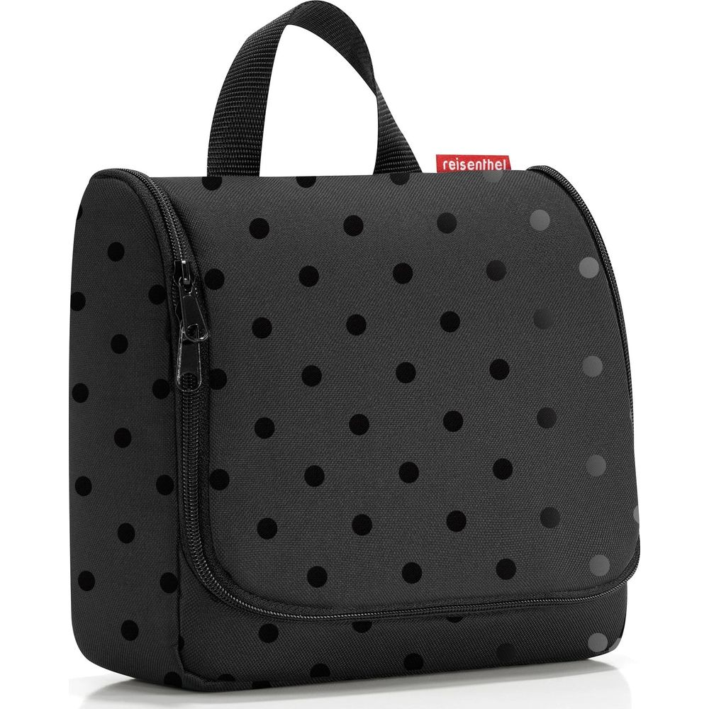 Schwarze Kulturtasche mit Punkten und Henkel, Reißverschluss vorne.