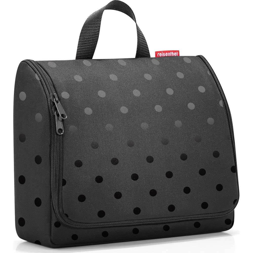 Schwarze Kulturtasche mit Tupfenmuster und Reißverschluss.